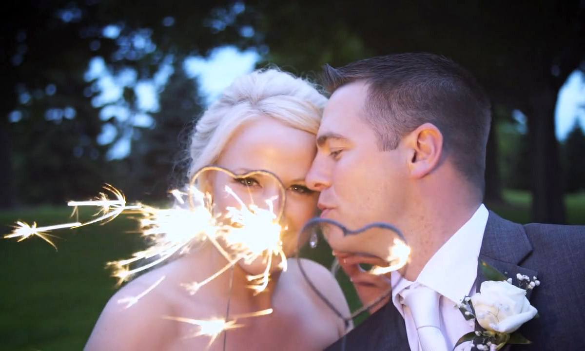 Couple holding heart shaped wedding sparklers
