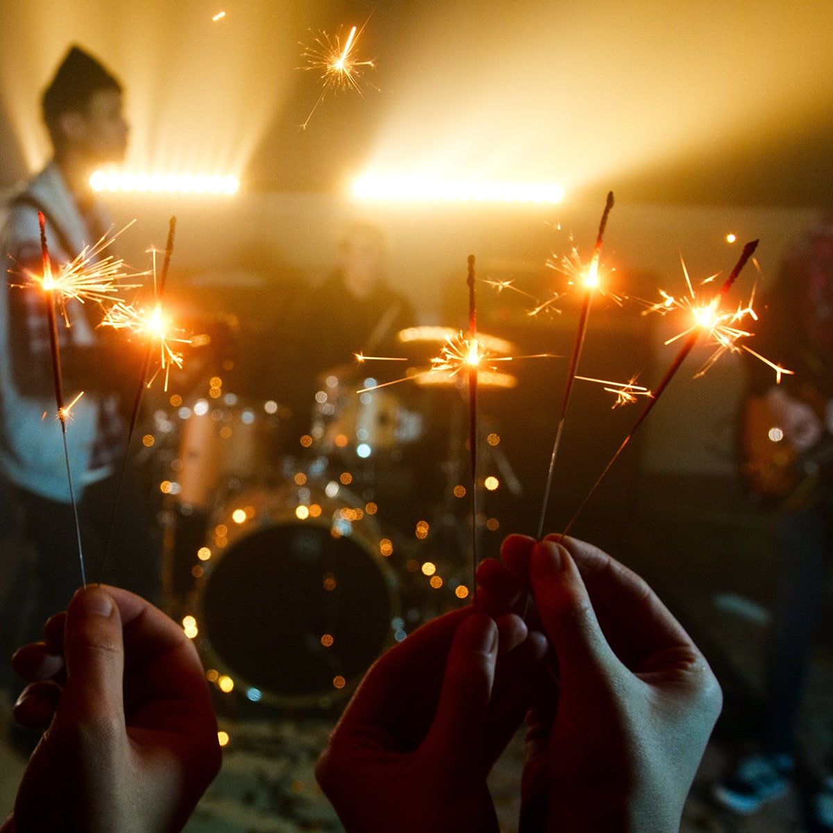 People holding sparklers during a concert